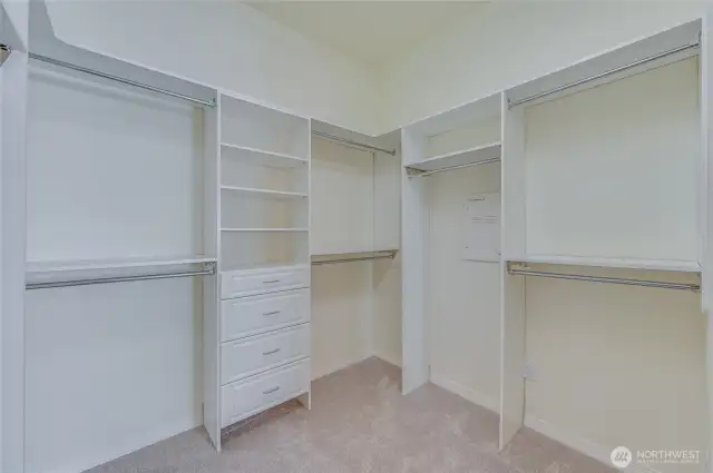 Primary walk-in closet with organizers.