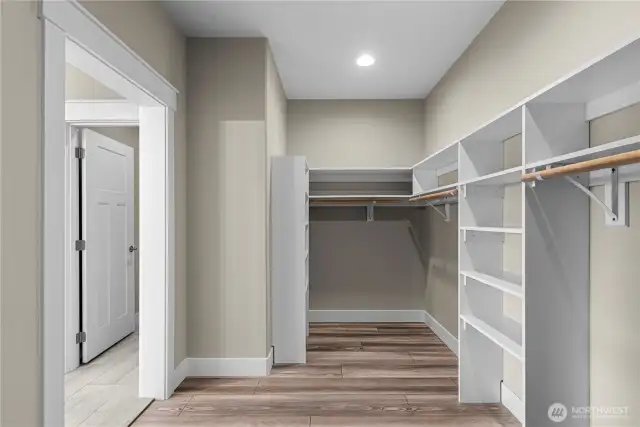 Primary Bedroom Walk In Closet w/built in storage shelving