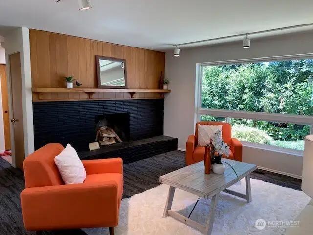 Living room, wood burning fireplace ,large front picture window creates plenty of natural light