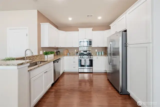 Built-in pantry on right side has deep upper and lower cabinets.