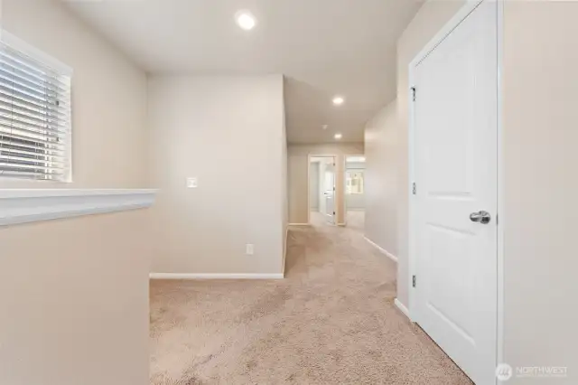 The large upstairs hallway gives this home an upgraded elegance. The linen closet is the door on the right side.