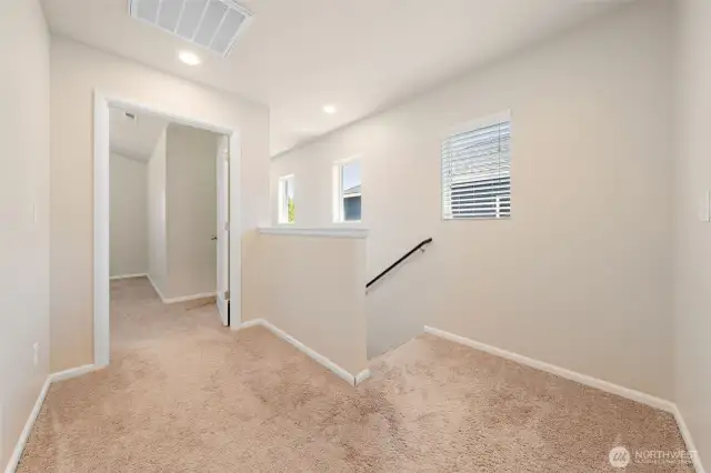 The pop of windows outline the stairway for extra light and the primary bedroom is located just at the top of the stairs.