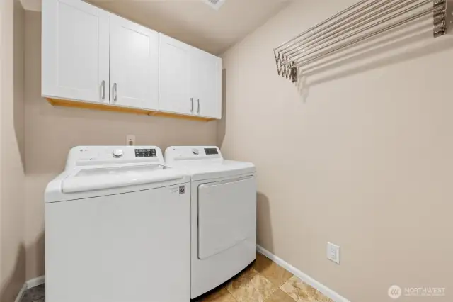 Upstairs laundry room makes this chore much easier.  Upper cabinets and pull out drying rack adds function and storage to this room.