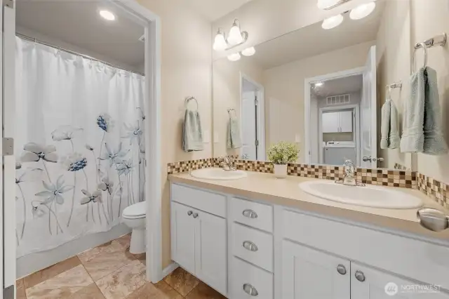 The guest bathroom's double vanity and separate room for tub/toilet makes it so easy for more than one person to get ready in the morning.
