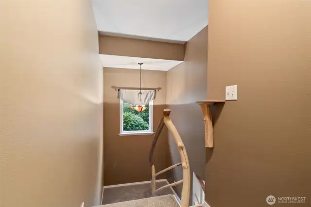 Custom handcrafted railing leading upstairs.