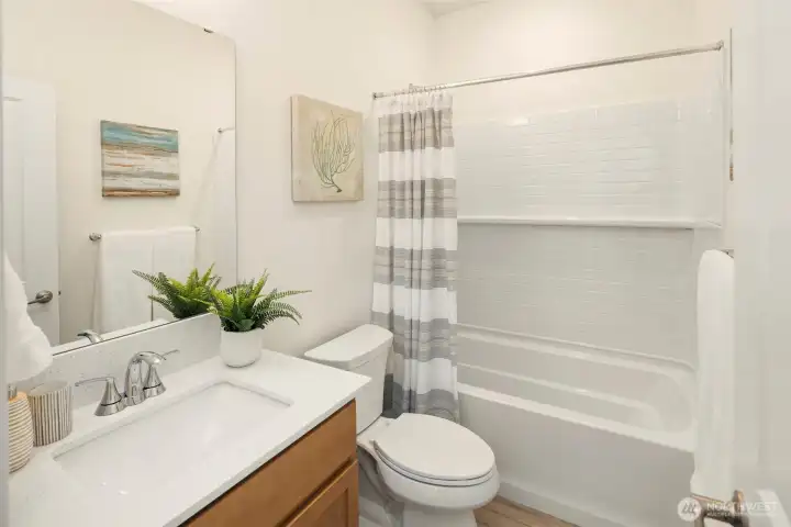 The full sized main level bathroom with shower over the tub. Located right next to the 5th bedroom / Den