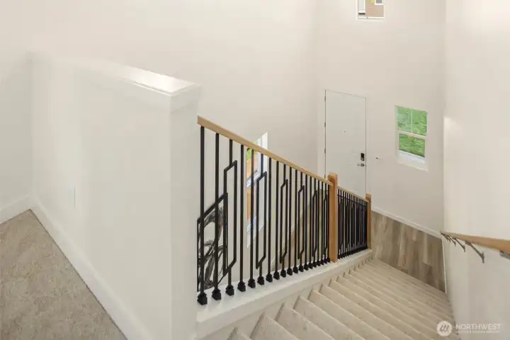 Lovely metal staircase railings and plush new carpeting throughout the upstairs