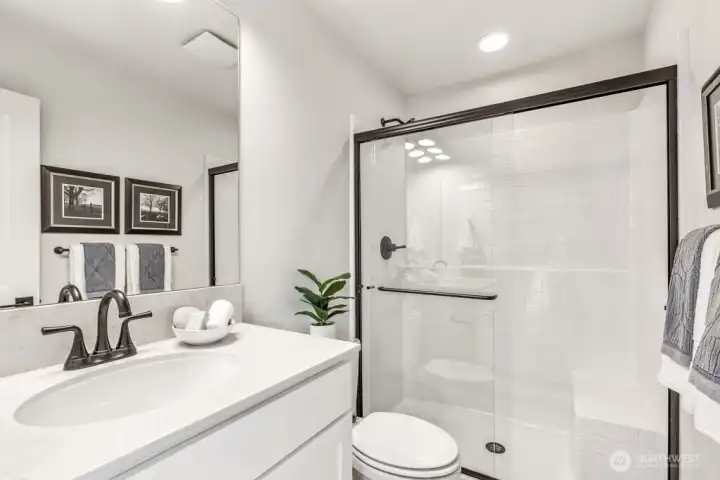 Ensuite-bath on second story. Interior photos are of the Sheridan model home at Maywood Heights. Same floor plan but colors and finishes will vary. Photos are for illustration purposes only.