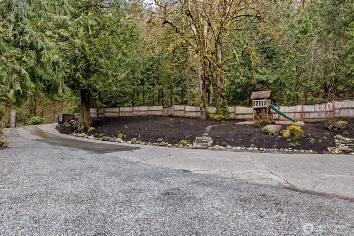 large drivway entrance with tons of privacy and safe play space