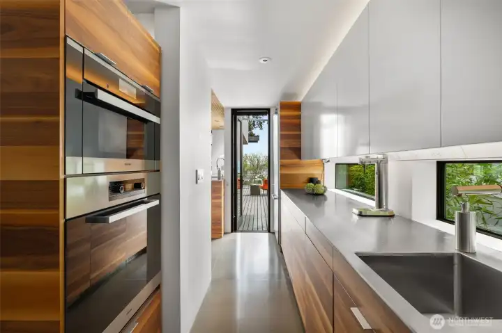 Double oven, over-sized Miele fridge, Italian cooktop, 1.5 dishwashers, wine fridge are sleekly built in