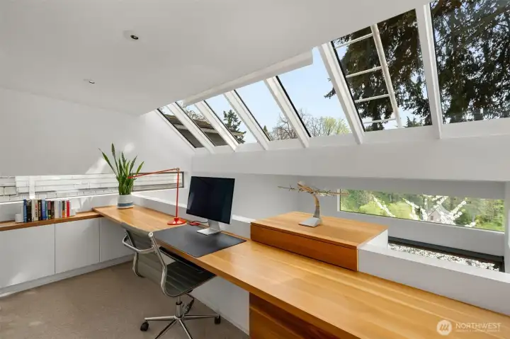 The ultimate office. Thoughtful custom cabinets and tree house views of the lush surroundings