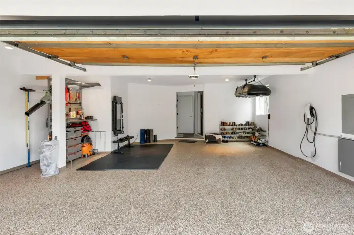 Over-sized, two car garage with EV charger, workout area, storage and workshop
