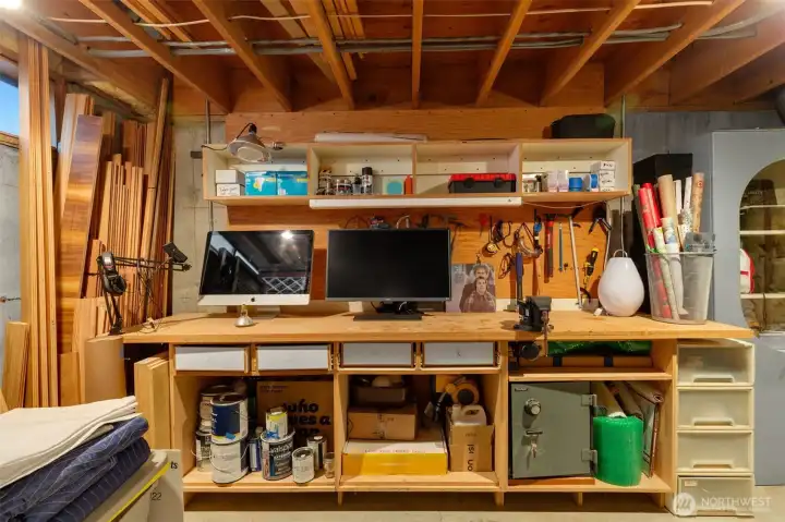 Lower utility room also includes a large workbench and storage