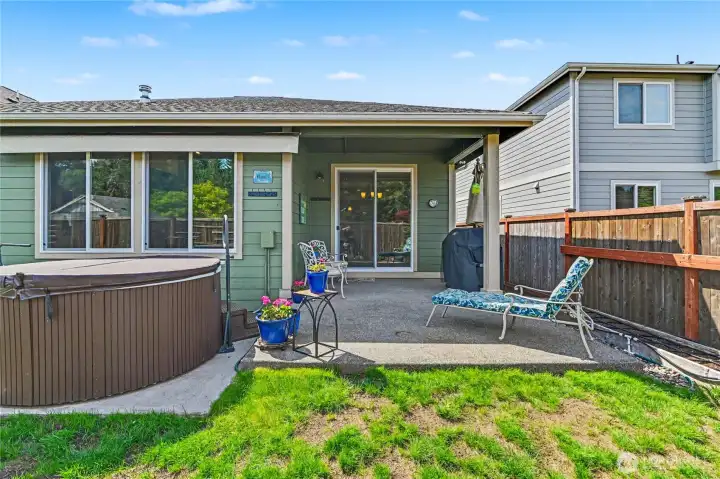 Backyard is easy to maintain with mature native plants and a well-maintained hot tub that conveys!