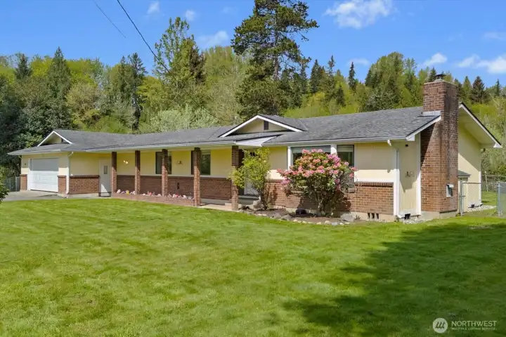 Sprawling ranch-style home featuring classic brick accents and a low-maintenance exterior. The expansive acreage provides a private, serene setting.