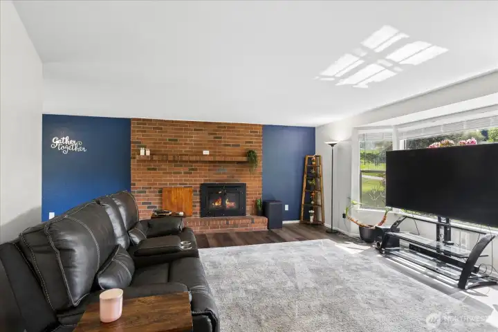 Enter to find new LVP flooring throughout the home.   A spacious living room centered around a floor-to-ceiling brick fireplace greets you upon entry. Large bay windows flood the space with natural light.