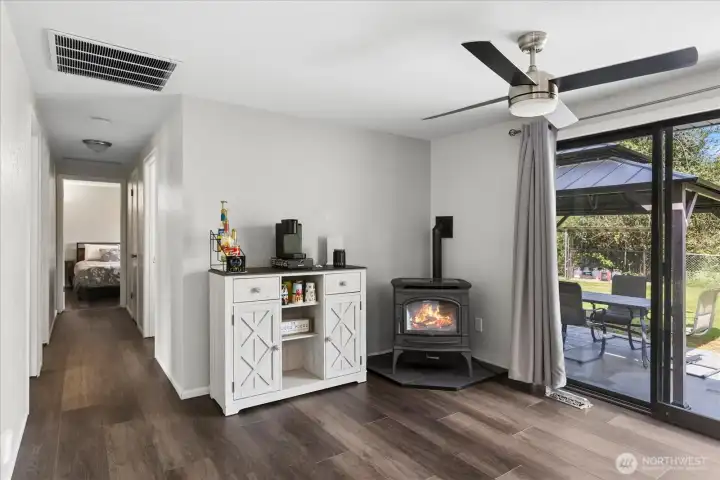 Eating area off the kitchen featuring a pellet stove and sliding glass doors that lead directly to the outdoor patio and entertaining area.