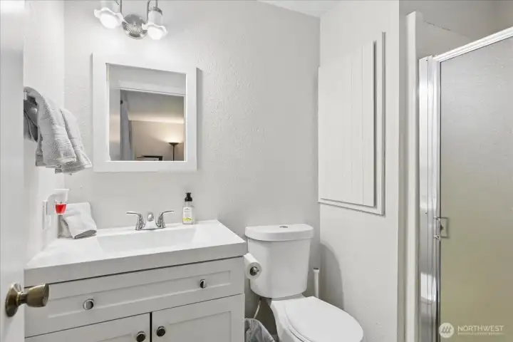 The primary en-suite with updated vanity & walk-in shower.