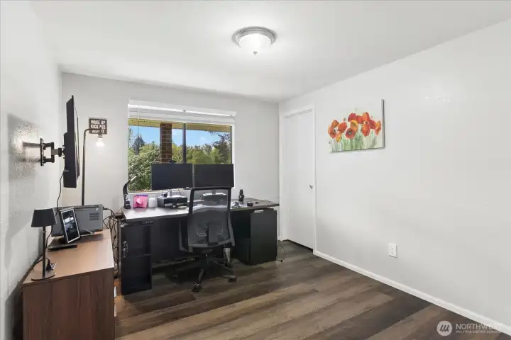 Versatile secondary bedroom currently configured as a home office with a small walk-in closet.