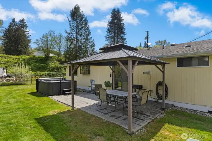 Spacious patio with gazebo and a hot tub just off the sliding glass door.  Great for entraining or just relaxing and soaking it all in!
