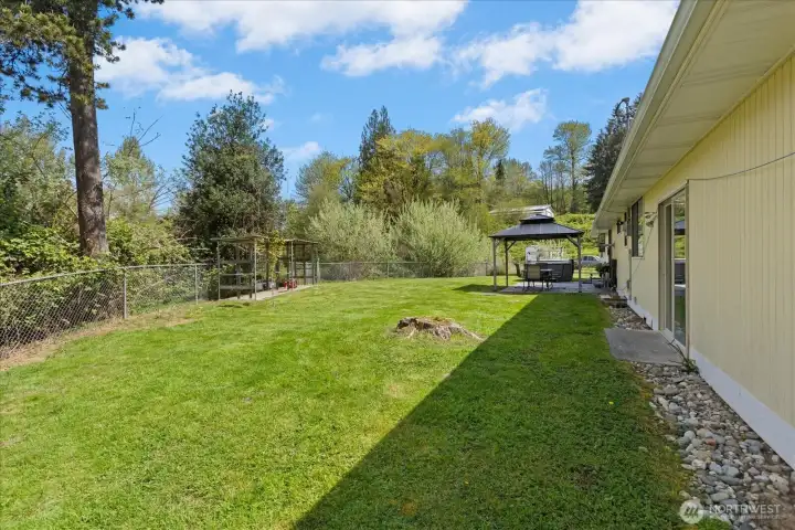 The private backyard is fully fenced for your furry friends and the expansive acreage is beyond.