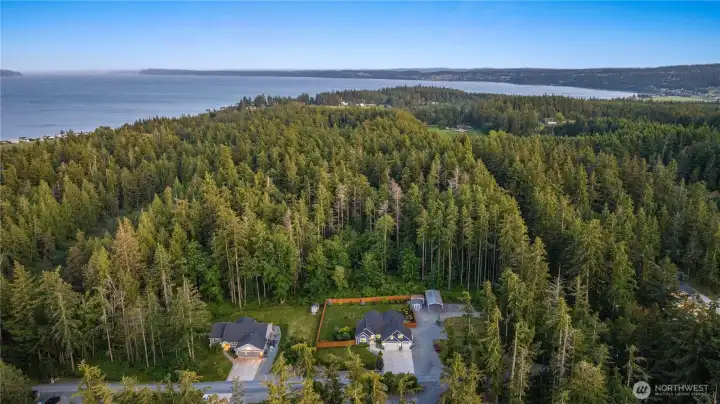 Set on over an acre of private, level grounds on North Camano Island...