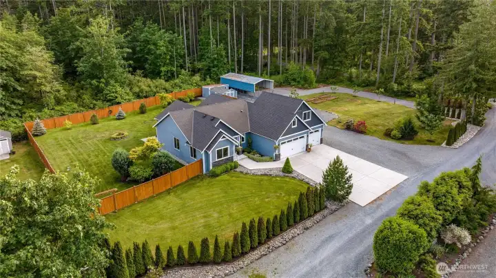 Rainbird sprinkler system, circular driveway, covered RV parking, & detached sheds!