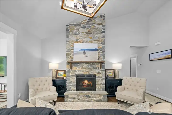 Custom stone fireplace anchors the great room & creates a welcoming atmosphere.