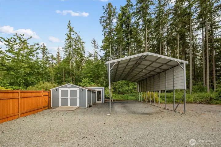Two sheds w/electricity & big covered RV parking space.