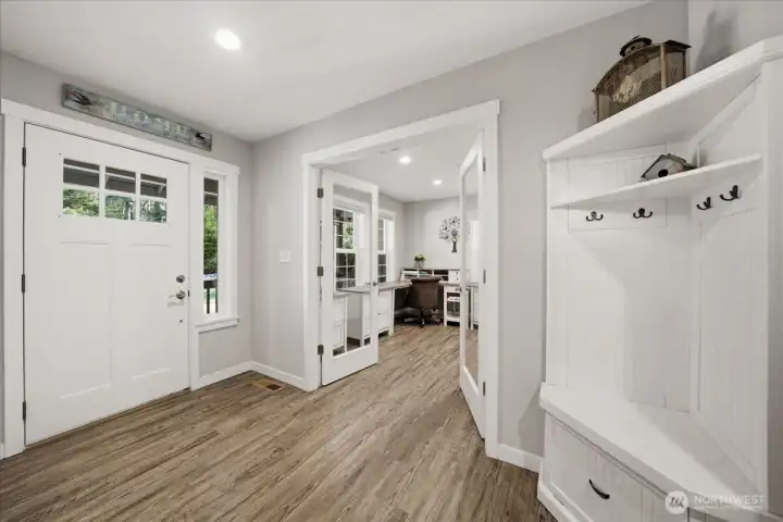 Entry with double doors leading to den