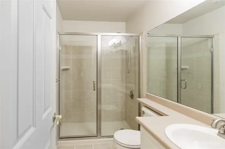 Upstairs tiled extended shower.