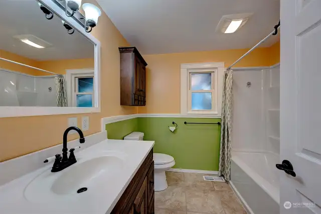 Second bathroom offers a new tub surround, new vanity and toilet.