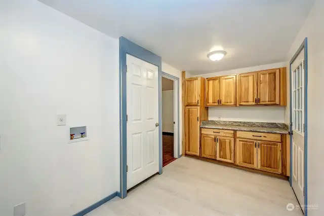 Spacious walk-in laundry room with new cabinetry, enter from the garage or family room.