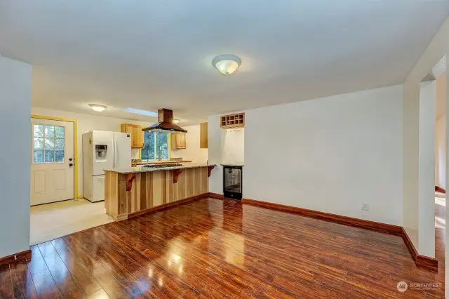 Welcoming entry leads to the family room with wine duel zone wine cooler and new flooring.