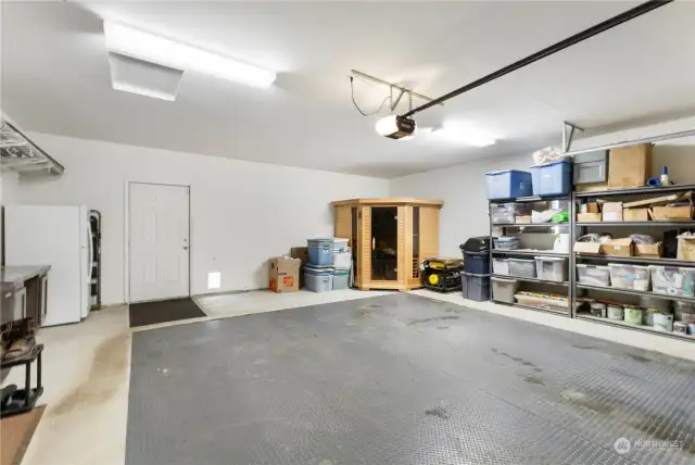 Spacious garage with the door leading to the dog run and coop area. The outside freezer and sauna do NOT stay.