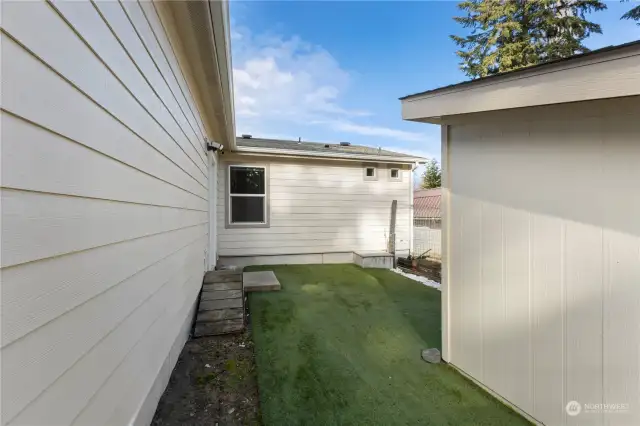 Enclosed dog run with artificial turf. Small doggie door leads in to the garage (door on the left).