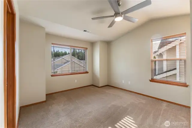 Primary Bedroom with vaulted ceiling and fan
