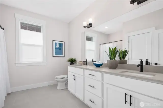 Main bath w/qtz counters, dual sinks, tile floor and tub/shower combo.  All pictures are of model home.  Layout is the same, but materials and colors will vary.