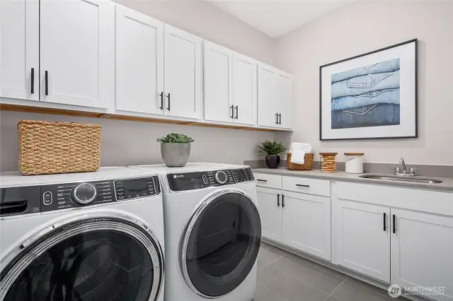 Doing Laundry just might be fun after all. Check out this huge laundry room w/cabinets, sink, quartz countertop. (W/D not included).  All pictures are of model home.  Layout is the same, but materials and colors will vary.
