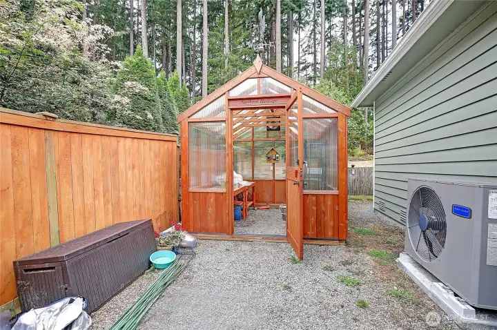Side yard offers plenty of space for a potting shed and all of your gardening needs!