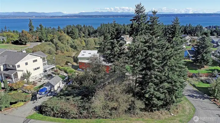 Stunning perspective looking East toward Port Susan Bay and the Cascades. A serene Camano Island neighborhood with no ferry required.
