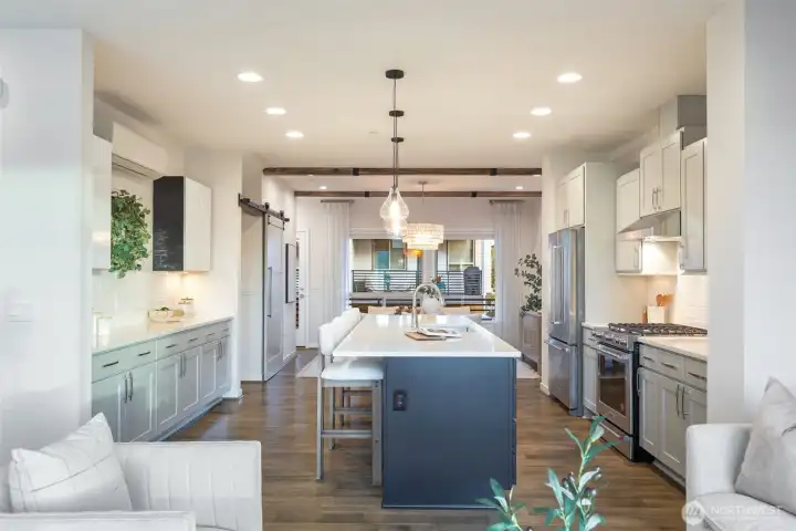 Stylish kitchen updated with custom cabinet paint, lighting, and tile backsplash.