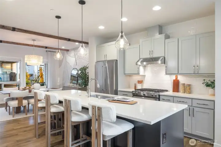 Oversized island makes food prep and dining seamless.