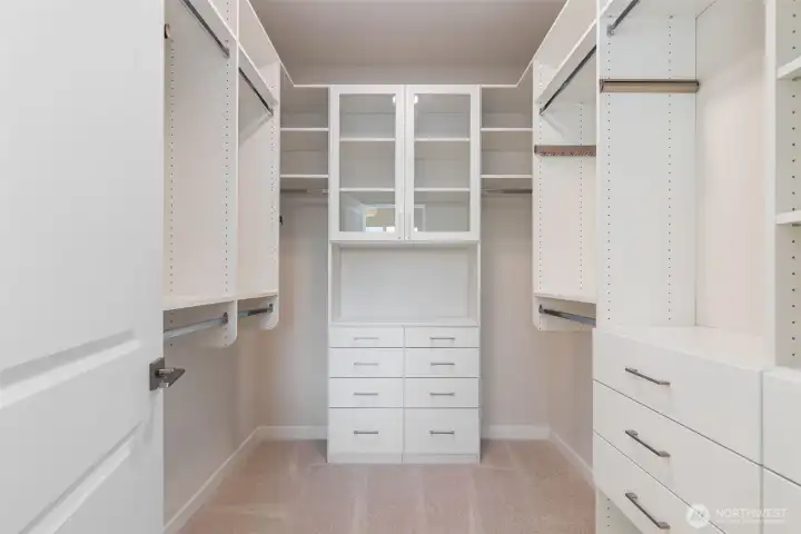 Large primary closet with custom built ins.