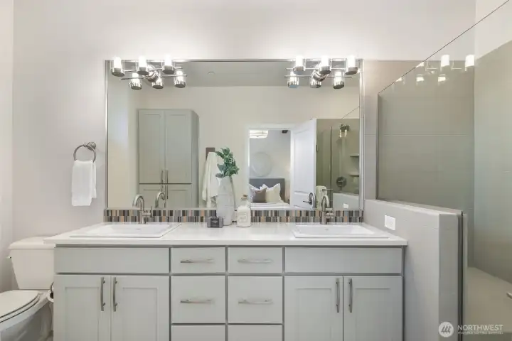 Ensuite primary bath with ample storage and tasteful colors.