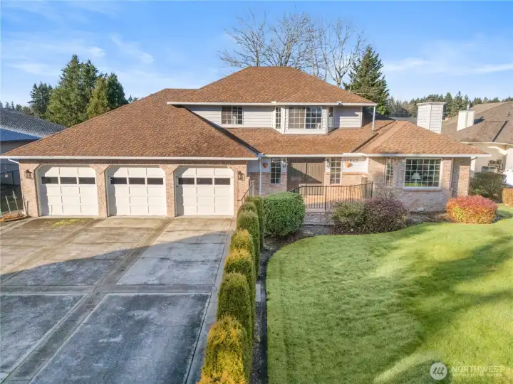 Front facing view of the home with a 5 car garage and plenty of room for additional parking.