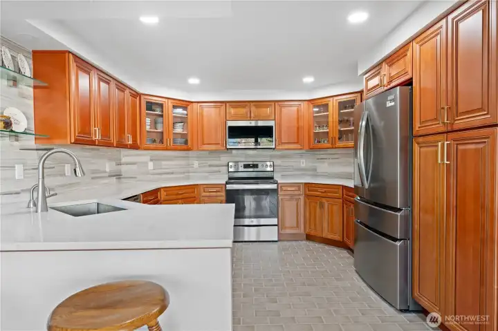 Brand new kitchen with quartz countertops and stainless steel appliances.