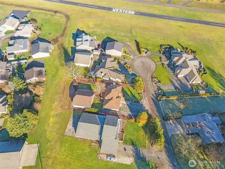 Overhead of the home showing proximity to runway. Outlines are estimates only - buyer to verify.