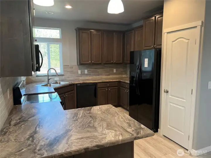 Large kitchen with plenty of cabinets and a pantry too.