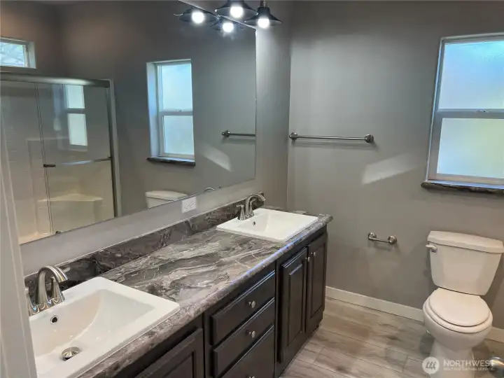 Primary bathroom with double vanities.